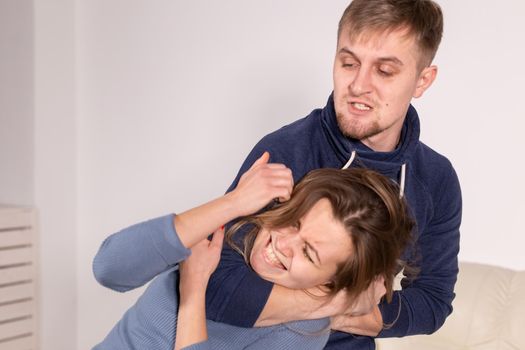 People, abuse and domestic violence concept - Portrait of man beating woman at home.