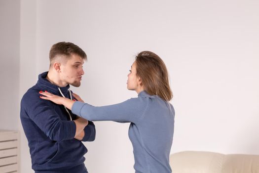 people, abuse and violence concept - agressive man strangling his wife.