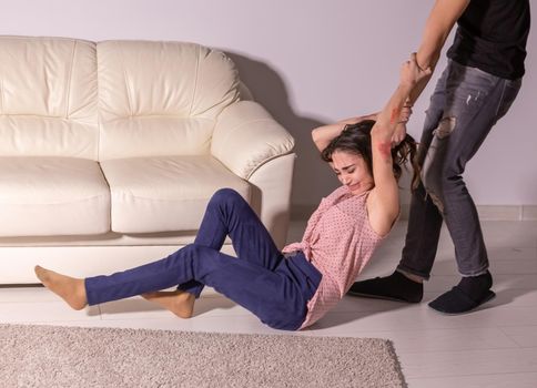 People and domestic violence - man and woman having fight, man dragging helpless woman by hair.