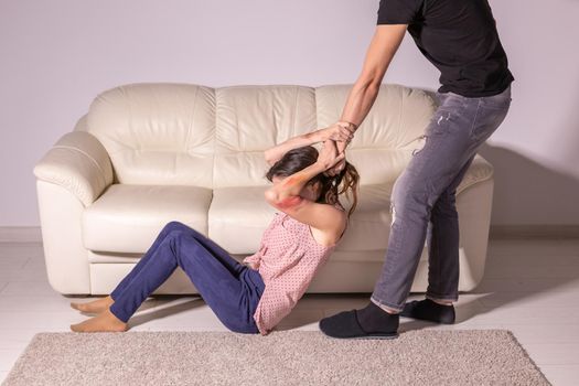 People and domestic violence - man and woman having fight, man dragging helpless woman by hair.