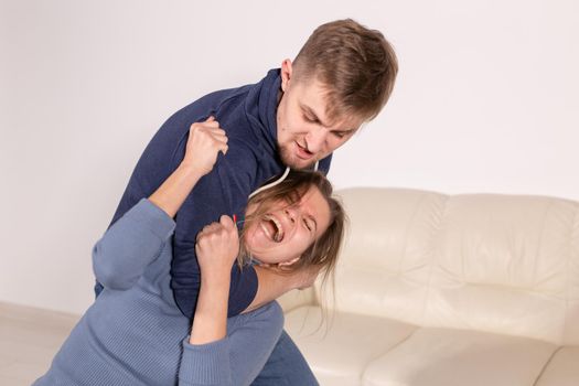 People, abuse and domestic violence concept - Portrait of man beating woman at home.