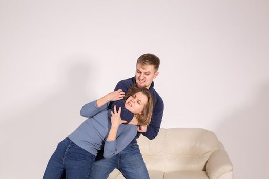 people, abuse and violence concept - agressive man strangling his wife.