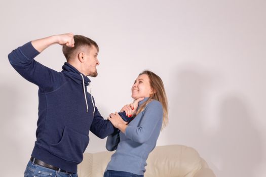 People and abuse concept - Portrait of angry young man try to hit the woman.