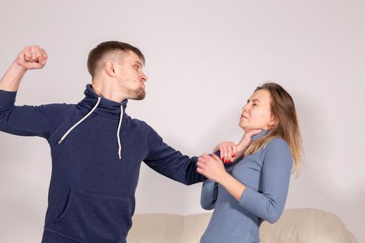 People and abuse concept - Portrait of angry young man try to hit the woman.