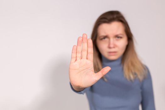 Abuse, domestic violence, protesting and people concept - Stop violence against women on grey background with copy space.