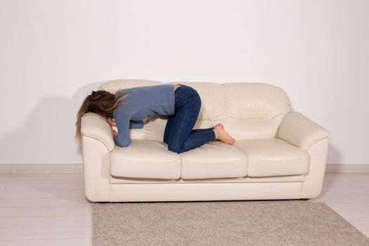 People, violence and abuse concept - Man drinking alcohol while wife is lying on sofa.