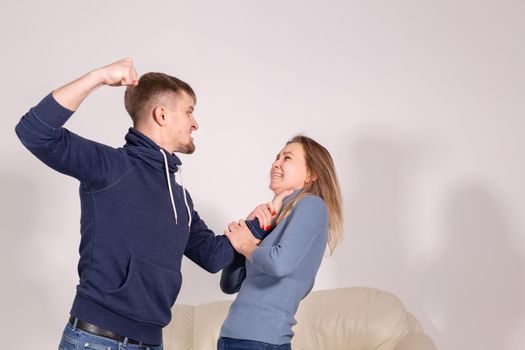 People and abuse concept - Portrait of angry young man try to hit the woman.