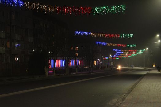 Lighting in the festive new year Christmas evening ima . Electricity consumption in the city night lighting.