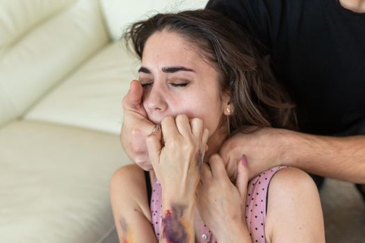 Victim, abuse and domestic violence - cruel man strangling his wife.