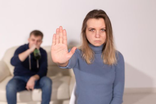 Alcoholism, abuse and problem concept - Sad woman shows stop sign, stop domestic violence.