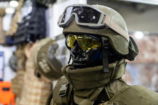 Mannequin in army uniform and equipment. Safety helmet and goggles. Special radio communication device. Modern warfare facilities