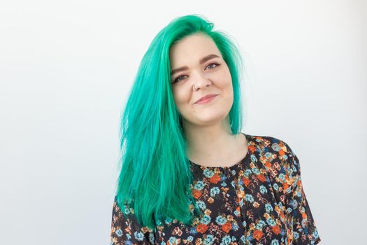 Fashion and people concept - Portrait of beautiful girl with green hair on a white background.