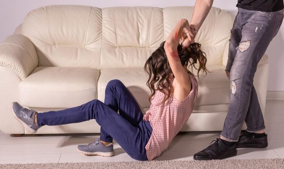 People and domestic violence - man and woman having fight, man dragging helpless woman by hair.