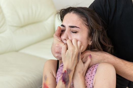 Victim, abuse and domestic violence - Cruel man covers woman's mouth.