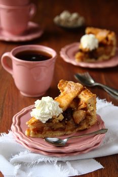 Slice of homemade dutch apple cake with whipped cream