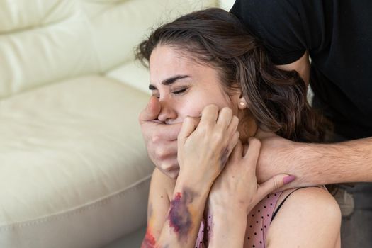 Victim, abuse and domestic violence - Cruel man covers woman's mouth.