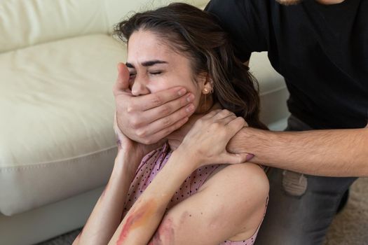 Victim, abuse and domestic violence - Cruel man covers woman's mouth.