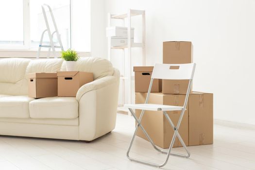 Folding chair sofa and boxes are in the new living room when residents move to a new apartment. The concept of new buildings and comfortable housing for young people