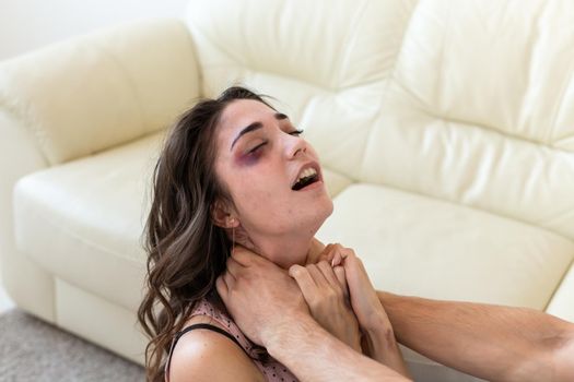 Victim, abuse and domestic violence - Woman being abused and strangled by strong man.