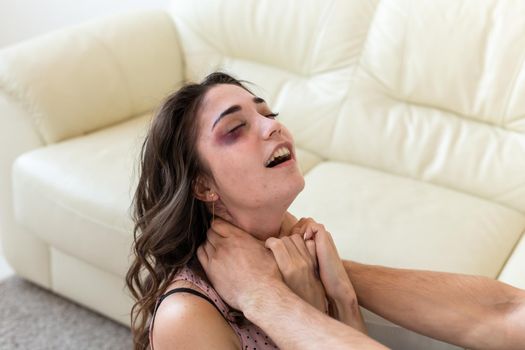 Victim, abuse and domestic violence - Woman being abused and strangled by strong man.