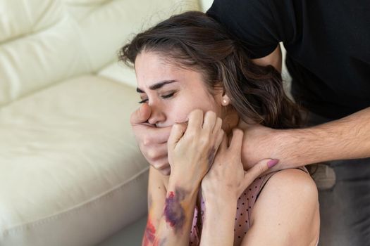 Victim, abuse and domestic violence - Cruel man covers woman's mouth.