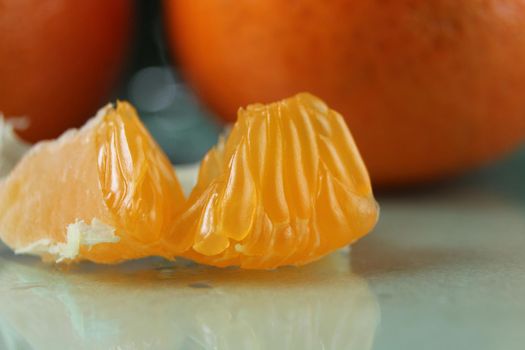 slice a piece of tangerine close-up. Orange citrus with white veins. food close-up.