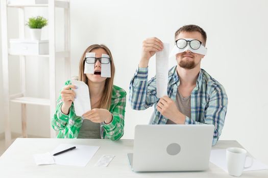 Young upset husband and wife were upset because of numerous expenses on paying for housing and communal services and repairing the apartment. covering their eyes with checks and ears with their hands