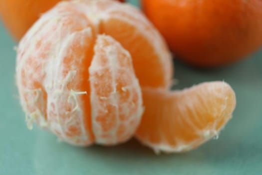 slice a piece of tangerine close-up. Orange citrus with white veins. food close-up.