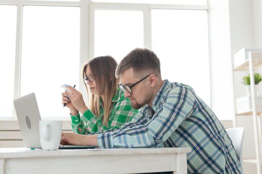 Dissatisfied young husband and wife recount utility bills for payment of an apartment and write the results in a notebook