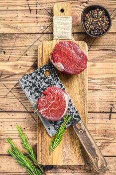 Raw beef meat steak Tenderloin fillet. Wooden background. Top view.