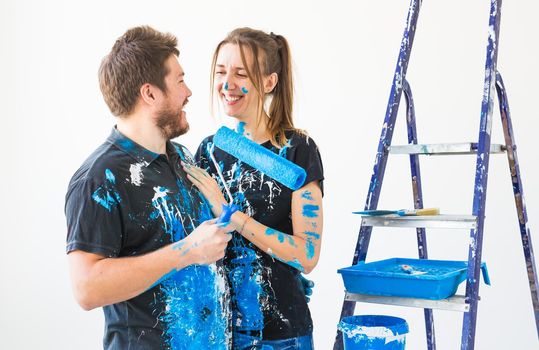 People, renovation and repair concept - Portrait of lovely couple doing redecoration in apartment.