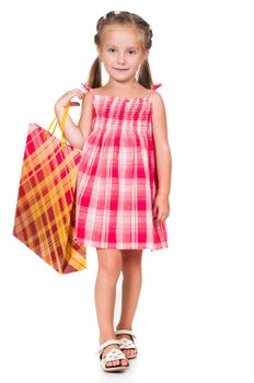 Adorable little girl with shopping bag isolated on a white background