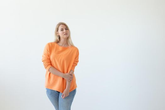 Portrait of pretty young woman in casual clothes posing on a white background. Space for reference links or advertising.