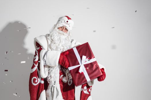 santa claus with long white beard with a gift in his hands, picture isolated on white background