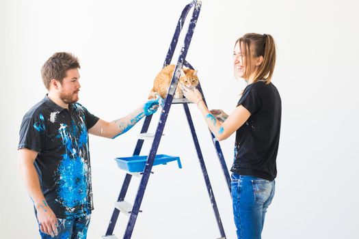 People, renovation and repair concept - Portrait of lovely couple doing redecoration in apartment.