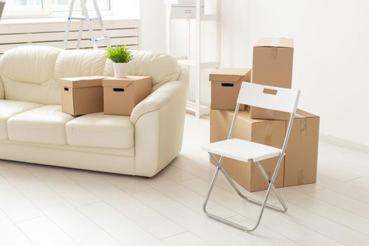 Folding chair sofa and boxes are in the new living room when residents move to a new apartment. The concept of new buildings and comfortable housing for young people