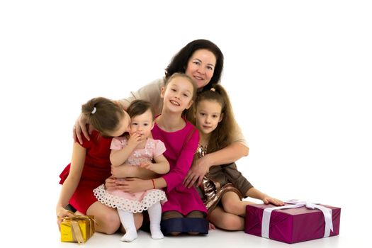 Happy young mother with children in the studio on a white background. The concept of family values, the upbringing of children. Isolated.