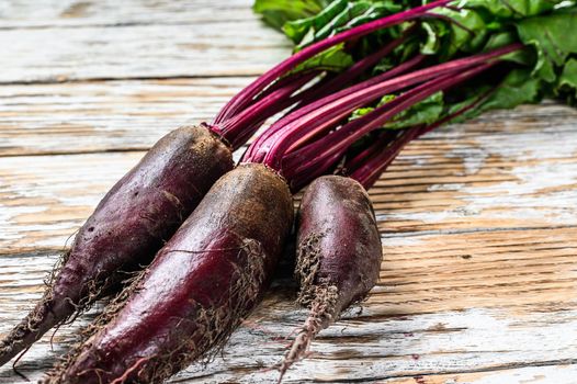 Organic purple beets. Wooden light background. Top view. Copy space.
