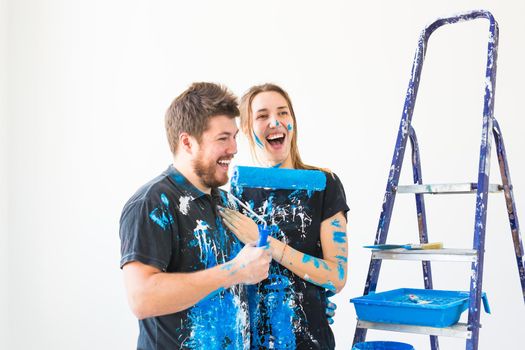 People, renovation and repair concept - Portrait of lovely couple doing redecoration in apartment.