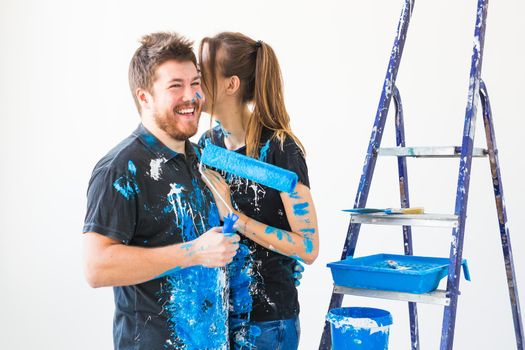 Renovation, repair and family concept - a young couple doing a repair in new home.