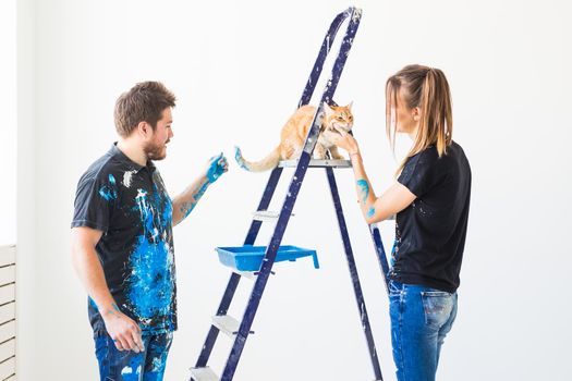 People, renovation and repair concept - Portrait of lovely couple doing redecoration in apartment.