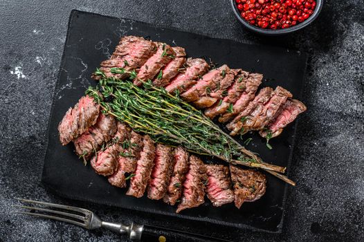 Skirt machete grilled meat beef Steak. Black background. Top view.