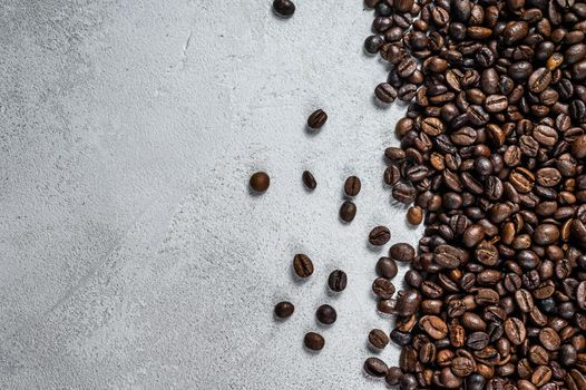 Roasted coffee beans on rustic table. White background. Top view. Copy space.