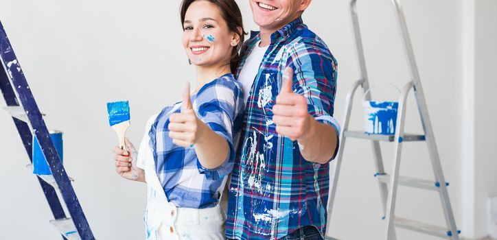 Redecoration, renovation and people concept - Woman and man gestured thumbs up.