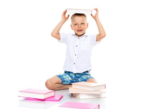 A cute little boy, a preschooler with books. The concept of education, the intellectual development of the child in the family. Isolated on white background.