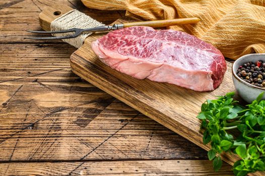 Raw Top Blade beef meat steak. wooden background. Top view. Copy space.