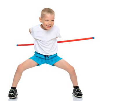 A cute little boy in a clean white T-shirt shows the exercises that he does when practicing fitness. The concept of advertising sports goods, it is possible to inscribe on a white T-shirt. Isolated on white background.
