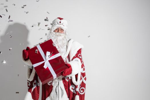 santa claus with long white beard with a gift in his hands, picture isolated on white background