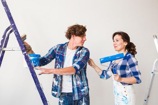 People, renovation and repair concept - Portrait of lovely couple doing redecoration in apartment.