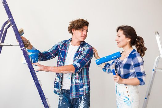 People, renovation and repair concept - Portrait of lovely couple doing redecoration in apartment.